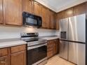 Kitchen featuring wood cabinets, stainless appliances, and hardwood floors at 4719 Altha St, Raleigh, NC 27606