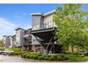 Modern building with neutral tones, balconies and lush landscaping for a contemporary feel at 515 N Churton St # 203, Hillsborough, NC 27278