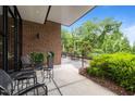 A brick patio with black metal chairs and tables and view of landscaped grounds at 515 N Churton St # 203, Hillsborough, NC 27278