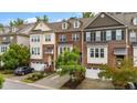Charming brick townhome with attached garages, front stairs, and manicured landscaping at 5321 Cambridgeshire Loop, Cary, NC 27519