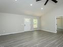 Bright living room featuring gray flooring and a white front door at 5576 Foothills Ct, Snow Camp, NC 27349