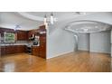 View of the living room open to the kitchen with hardwood floors at 5820 Wake Forest Hwy, Durham, NC 27703