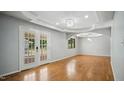 Sunlit living room with hardwood floors and a French door, offering access to outdoor living space at 5820 Wake Forest Hwy, Durham, NC 27703