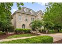 A beautifully landscaped brick home with a well-maintained lawn and a charming, inviting exterior, perfect for Gathering living at 6005 Carlyle Dr, Raleigh, NC 27614