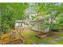 Backyard brick patio surrounded by trees, and lush foliage at 604 Eden Ln, Chapel Hill, NC 27517