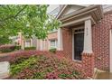 Inviting entryway featuring brick accents, neat landscaping, and a welcoming front door at 615 Carlton Commons Ln, Cary, NC 27519
