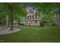 Charming two-story home featuring a welcoming front porch and well-maintained landscaping at 618 Durwood Dr, Raleigh, NC 27603