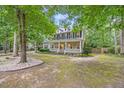 Charming two-story home featuring a welcoming front porch and well-maintained landscaping at 618 Durwood Dr, Raleigh, NC 27603