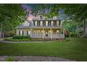 Charming two-story home featuring a welcoming front porch and well-maintained landscaping at 618 Durwood Dr, Raleigh, NC 27603