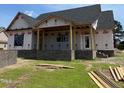 Exterior of home with brick foundation and framed porch area at 6332 River Rd, Fuquay Varina, NC 27526