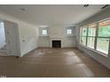 Spacious living room features a fireplace with built-in cabinets and large windows at 701 Locust Ln, Raleigh, NC 27603