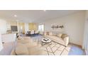 Bright, open-concept living room with neutral tones, a modern rug, and ample seating for entertaining at 724 Shepard Rock Dr, Zebulon, NC 27597
