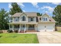 Charming two-story home with a welcoming front porch and well-manicured lawn at 105 Rolling Stone Ct, Sanford, NC 27332