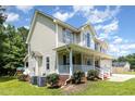 Two-story home with covered porch, manicured bushes and a two-car garage at 105 Rolling Stone Ct, Sanford, NC 27332