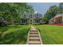 Inviting front yard with a stone walkway leading to the house at 1110 Edgewood Ave, Burlington, NC 27215