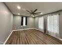 Spacious bedroom with a modern ceiling fan, neutral walls, and wood-look flooring at 119 N Anthony St, Burlington, NC 27217