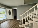 Inviting foyer with durable wood floors, a staircase, and a view of the entry at 119 N Anthony St, Burlington, NC 27217