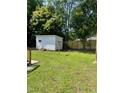 Backyard with a storage shed, trees, clothes line and green lawn at 1210 Fayetteville St, Smithfield, NC 27577