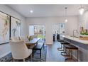 Light-filled dining area with an adjacent open-concept kitchen, with access to outdoor living space at 1227 Bessie Ct, Wake Forest, NC 27587