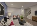 Comfortable living room with modern decor, plush seating, and beautiful accent wall design at 1227 Bessie Ct, Wake Forest, NC 27587
