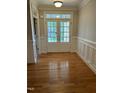 Inviting foyer with hardwood floors, classic trim, and double glass front doors letting in ample light at 126 Riverglade Dr, Clayton, NC 27527