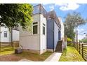 Modern two-story home featuring a rooftop deck, blue siding, and a manicured lawn at 1314 S East St, Raleigh, NC 27601