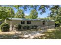 Home featuring a green metal roof, white siding, and a fenced yard at 1355 Sykes Rd, Spring Hope, NC 27882