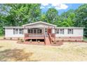 Charming single-story home with a cozy front porch and a well-maintained yard at 141 S Creek Dr, Louisburg, NC 27549