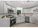 Bright kitchen features white cabinets, modern appliances, and stylish countertops at 141 S Creek Dr, Louisburg, NC 27549