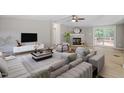 Spacious living room with ample seating, fireplace, and sliding door access at 141 S Creek Dr, Louisburg, NC 27549