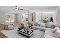 Open living room with adjacent kitchen and dining area, perfect for entertaining at 141 S Creek Dr, Louisburg, NC 27549