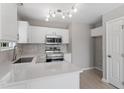 Well-lit kitchen features stainless steel appliances, sleek countertops, and ample cabinet space at 1941 White Memorial Church Rd, Willow Springs, NC 27592