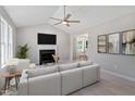 Inviting living room features a fireplace, large sofa, and seamless flow to adjacent dining area at 1941 White Memorial Church Rd, Willow Springs, NC 27592