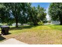 A spacious backyard with ample green space and mature trees for outdoor enjoyment at 2112 Mckinney St, Burlington, NC 27217