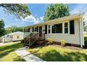 Side view of the home showcasing its clean lines, large windows, and convenient access at 2112 Mckinney St, Burlington, NC 27217