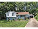Charming split-level home with a detached garage, landscaped front yard, and mature trees at 3509 Crofton Ct, Raleigh, NC 27604