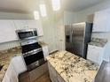 A lovely kitchen featuring granite counters, an island, and stainless steel appliances at 417 Downing Glen Dr, Morrisville, NC 27560