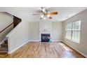 Inviting living room with hardwood floors, fireplace, and plenty of natural light at 417 Downing Glen Dr, Morrisville, NC 27560