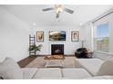 Cozy living room showcases a fireplace, hardwood floors, ceiling fan, and lots of natural light at 4508 Valley Crest Ln, Fuquay Varina, NC 27526