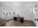Bright home office with hardwood floors, natural light from windows, and a modern desk at 4508 Valley Crest Ln, Fuquay Varina, NC 27526