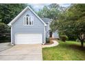 Beautiful home with a two-car garage, arched windows, and a well-maintained front yard at 7605 Sandy Lake Ct, Raleigh, NC 27613