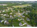 An aerial view shows a nice neighborhood, proximity to downtown Fuquay, with lush greenery and well-maintained homes at 817 Mossy Oak Dr, Fuquay Varina, NC 27526