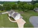 A back aerial view reveals a landscaped yard, a charming back patio, and a spacious driveway for parking at 817 Mossy Oak Dr, Fuquay Varina, NC 27526
