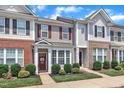 Charming townhome featuring well-maintained lawn and attractive front facade with appealing architectural elements at 886 Cupola Dr, Raleigh, NC 27603