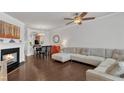 Cozy living room features a fireplace, hardwood floors, and an open layout to the dining area at 886 Cupola Dr, Raleigh, NC 27603