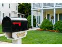 Close-up of mailbox in front of a charming two-story home with manicured lawn at 10415 Ashmead Ln, Raleigh, NC 27614