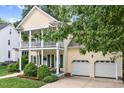 Charming two-story home with double front porch and attached two-car garage at 10415 Ashmead Ln, Raleigh, NC 27614