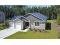 This single-story home features a two-car garage, neat landscaping, and a cozy front porch, perfect for relaxation at 108 Rocking Horse Ln, Sanford, NC 27332