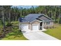 Charming single-story residence with a two-car garage, well-maintained lawn, and inviting front entrance in a serene setting at 108 Rocking Horse Ln, Sanford, NC 27332