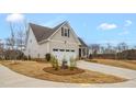 Well-maintained home featuring a covered porch and a two-car garage at 1119 Brookfield Dr, Gibsonville, NC 27249